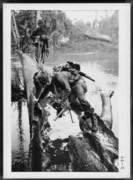 U.S. Soldiers Crossing a Fallen Tree