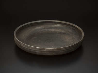 Carbonized unglazed flat bowl, named "Heian"